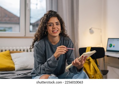 Portrait of a beautiful student preparing for the exam - Shutterstock ID 2256010063