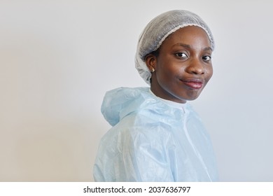 Portrait Of Beautiful Sweaty Young Smiling Medical Nurse In PPE Suit Lookig At Camera