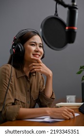 Portrait, Beautiful And Talented Asian Female Online Radio Host Or Podcaster Running Her Show In Her Professional Studio At Home.