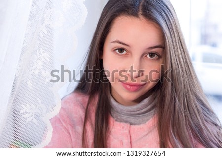 Portrait of beautiful teen girl smiling looking at camera.