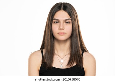 Portrait Of A Beautiful Teenage Girl With Long Straight Hair And No Makeup On A White Background