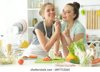 Portrait of a beautiful teenagers cooking in kitchen