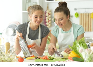 Portrait Of A Beautiful Teenagers Cooking In Kitchen