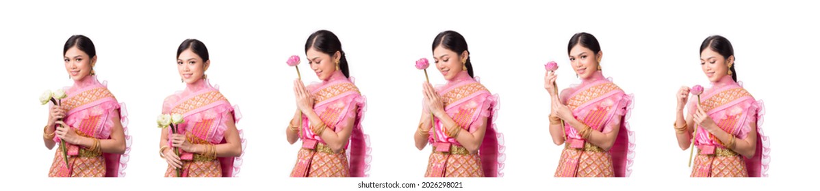 Portrait of Beautiful Thai girl in traditional costume With a lotus flower in his hand on white background