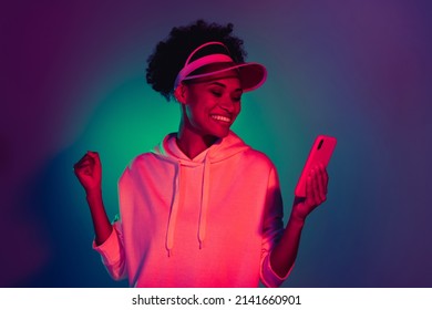Portrait beautiful trendy funky cheery girl using device smm app isolated over bright multicolor light gradient color background