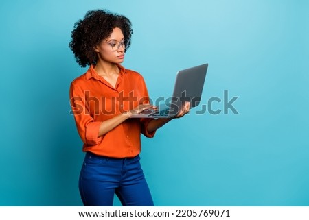 Portrait of beautiful trendy wavy-haired girl using laptop copy space study learn isolated on vivid blue color background