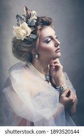 Portrait of beautiful victorian woman wearing pearl jewelry and veil around her shoulders