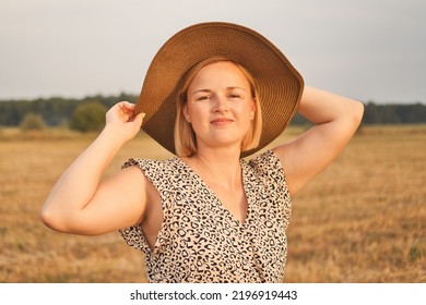 Portrait Of Beautiful White European Woman In Dress And Hat At Evening Time Outdoors.