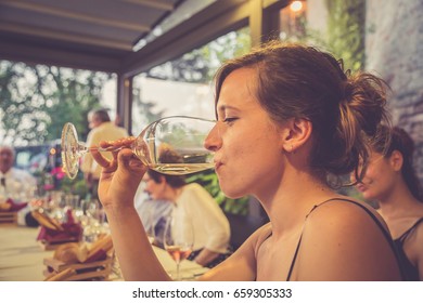 portrait of a beautiful wine tasting tourist woman in a restaurant