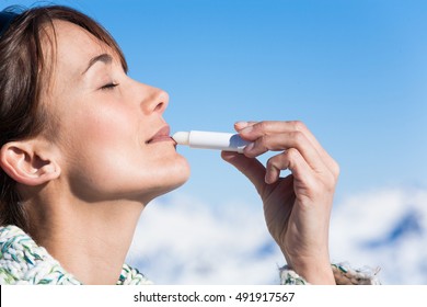 Portrait Of A Beautiful Woman With Application Of A Sunscreen On Her Lips
