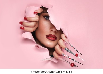 Portrait of a beautiful woman with art make up in glamorous style, creative long nails. Design manicure. Beauty face. Picture taken in the studio.