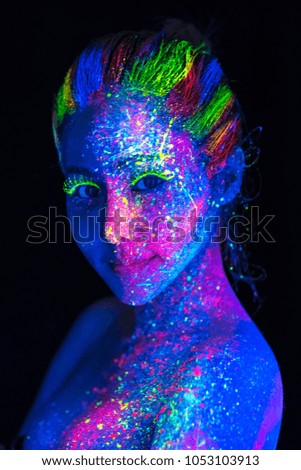 Portrait of Beautiful Woman with Art Make-Up in Color Light, Fashion Model with painted in fluorescent powder