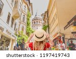 Portrait of beautiful woman backside with view of Galata tower in Beyoglu,Istanbul,Turkey