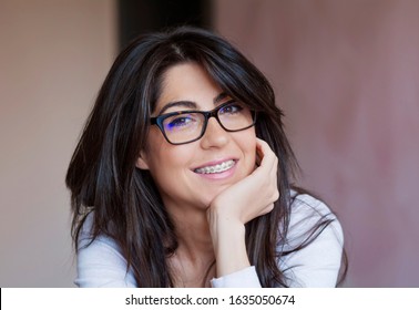 Portrait of a Beautiful Woman with Braces on Teeth. Orthodontic Treatment. Dental Care Concept