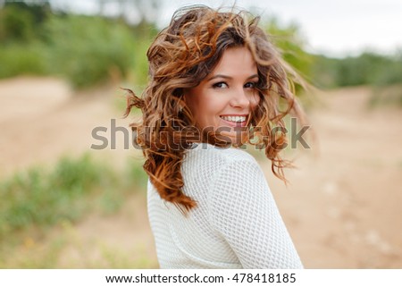 Portrait of a beautiful woman with flying hair in the wind, summer, closeup