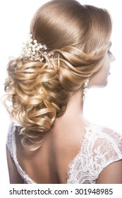 Portrait Of A Beautiful  Woman In Image Of The Bride. Picture Taken In The Studio On A Black Background. Beauty Hair. Hairstyle Back View