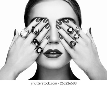 Portrait of beautiful woman with jewelry. Manicure and makeup. Perfect skin. Fashion beauty. Ring. Blonde girl. Close up. Black and white
