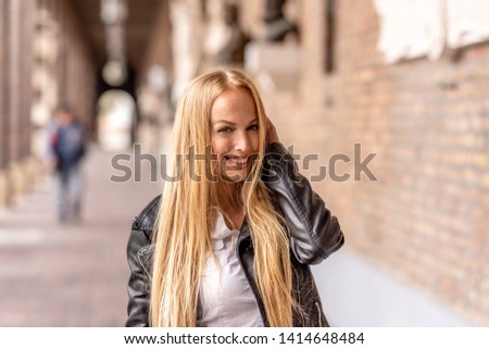 Similar – Happy young woman with moving hair in urban background