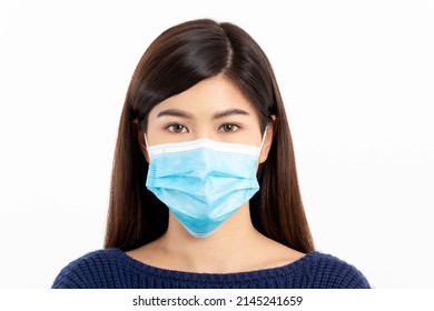 Portrait of a beautiful woman with long hair wearing a blue long-sleeved shirt and wearing a blue mask on a white background. Selective focus. - Shutterstock ID 2145241659