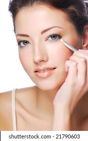 Portrait Of Beautiful Woman Making Make-up  Using White Eyeliner For Eyes