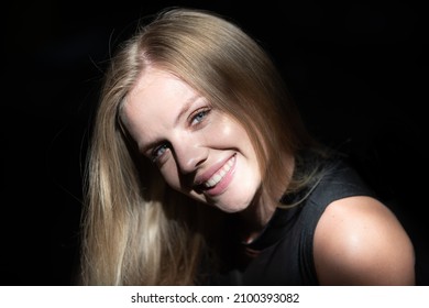 Portrait Of Beautiful Woman Model Looking Seductive And Sensual. Beauty Face With Dramatic Studio Light Isolated On Black. Blonde Girl Close Up Face.