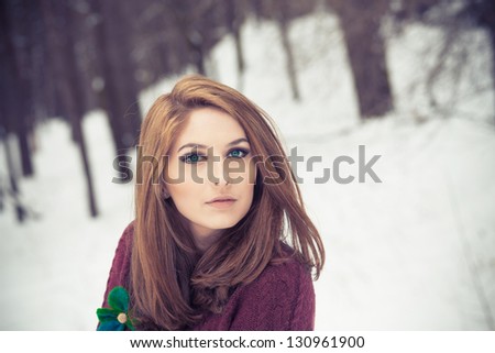 Portrait of a beautiful woman on winter park