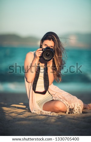 Similar – junge Frau beim Fotografieren mit Retro-Kamera auf Roadtrip