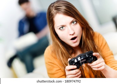 Portrait Of Beautiful Woman Playing Videogame At Home