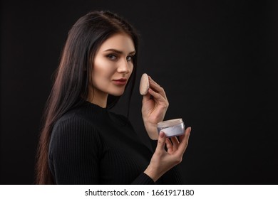 Portrait Of Beautiful Woman With Powder Puff. Girl Applying Makeup.