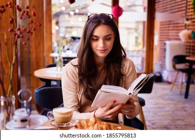 Portrait of beautiful woman reading a book while relaxing in the cafe.  - Shutterstock ID 1855795813