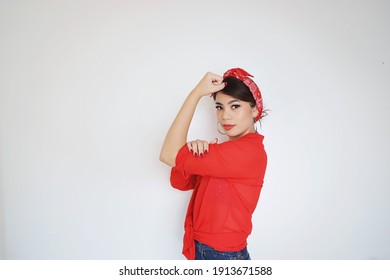 Portrait Beautiful Woman In Red Shirt Showing Her Bicep,We Can Do It,Woman’s Day Concept.