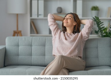 Portrait of beautiful woman resting on a sofa at home. - Shutterstock ID 2150035295