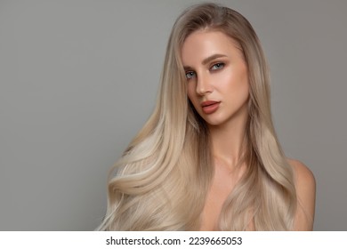 Portrait of a beautiful woman with shiny curly hair. Coloring blond - Shutterstock ID 2239665053