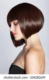 Portrait Of A Beautiful Woman In Short Brunette Bob With Neat Clean Hair On Studio Background