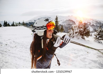 Portrait of beautiful woman with ski and ski suit in winter mountain - Powered by Shutterstock