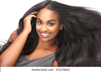 Portrait of a beautiful woman smiling with flowing hair isolated on white