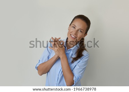 Similar – Young female sitting by table and making clay or ceramic mug in her working studio