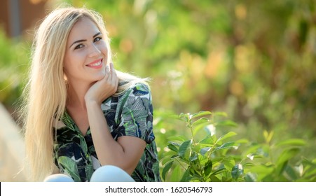 Portrait Of Beautiful Woman With Strait Hair. Walking In Sunflower Field