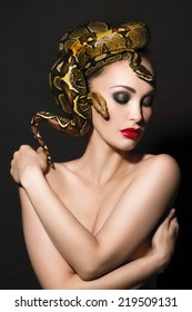 Portrait of Beautiful Woman in studio with dangerous snake