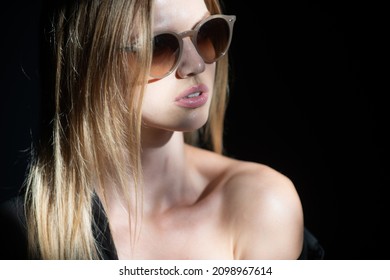 Portrait Of Beautiful Woman In Sunglasses Model Looking Seductive And Sensual. Beauty Face With Dramatic Studio Light Isolated On Black.