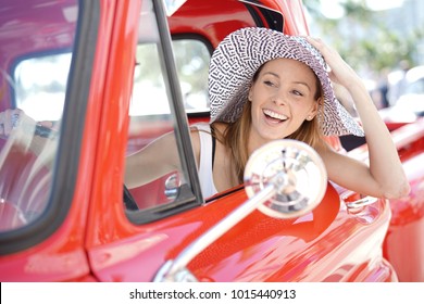 Portrait Of Beautiful Woman In Vintage Red Truck