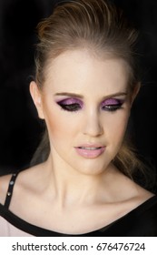 Portrait Of Beautiful Woman Wearing Edgy Makeup With Purple Sparkle Eyeshadow  And Dark Eyeliner. 