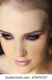 Portrait Of Beautiful Woman Wearing Edgy Makeup With Purple Sparkle Eyeshadow  And Dark Eyeliner. 