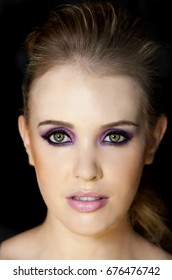 Portrait Of Beautiful Woman Wearing Edgy Makeup With Purple Sparkle Eyeshadow  And Dark Eyeliner. 