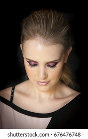 Portrait Of Beautiful Woman Wearing Edgy Makeup With Purple Sparkle Eyeshadow  And Dark Eyeliner. 