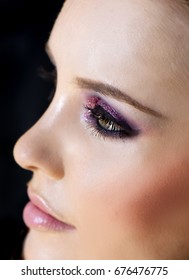 Portrait Of Beautiful Woman Wearing Edgy Makeup With Purple Sparkle Eyeshadow  And Dark Eyeliner. 