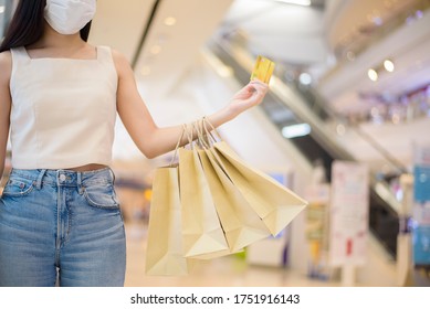 portrait of beautiful woman is wearing face mask in shopping center  - Shutterstock ID 1751916143