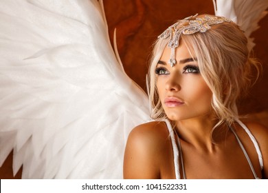 portrait of beautiful woman with white angel wings on