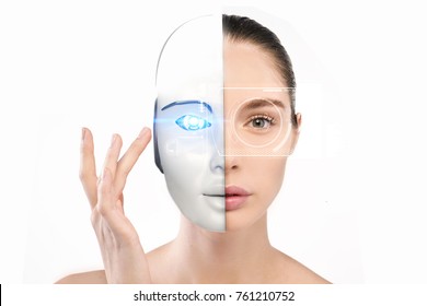 Portrait of a beautiful woman who with her hand crushes and half-face becomes a robot with artificial intelligence. Concept of: future, artificial intelligence, robot. - Shutterstock ID 761210752
