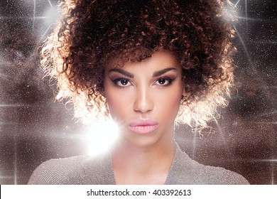 Portrait of beautiful young African American woman with afro and glamour makeup. Studio shot.
